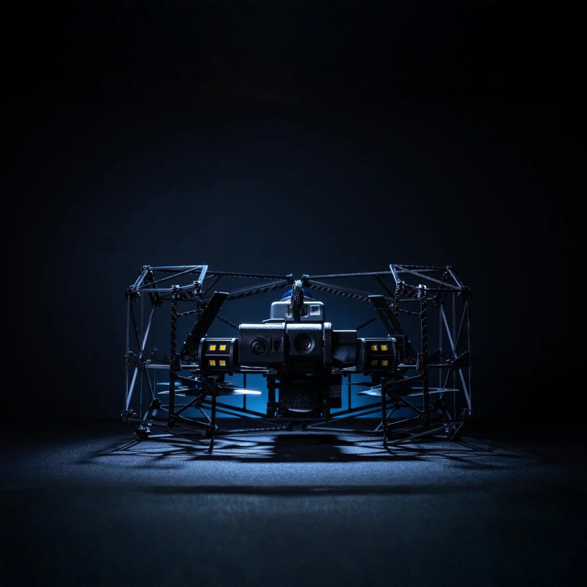 Nolvis X1 Dual Drone Package, caged indoor inspection drone on the ground in low light