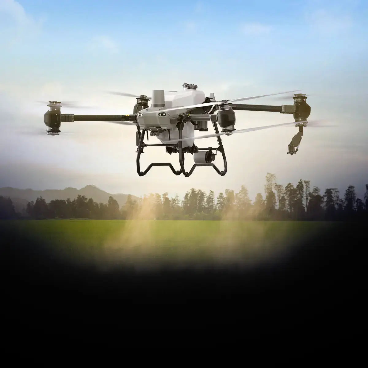 DJI Agras being used to spray crops in an open field.